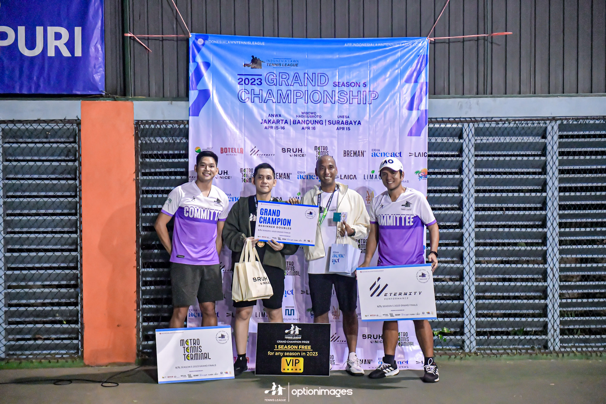 Beginner doubles champions holding their award at the medal presentation.